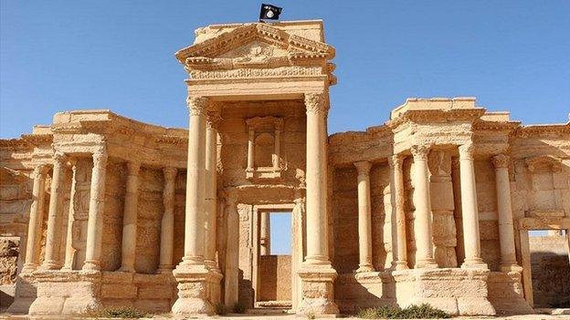 An image allegedly showing a flag of the Islamic State (IS) group flying above a Roman theatre in the ancient city of Palmyra - 17 June 2015