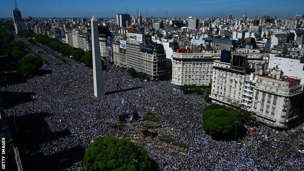 Hundreds of thousands Argentinians pack into Buenos Aires' Plaza de la República, which is where the World Cup winning-squad's bus parade will finish later on Tuesday