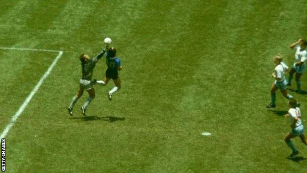 Diego Maradona scores Argentina's first goal against England in the 1986 World Cup quarter-final