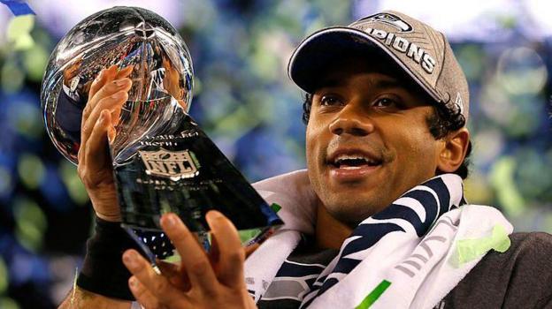 Russell Wilson holding the Lombardi Trophy after the Seattle Seahawks win the Super Bowl in 2014