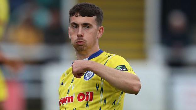 Midfielder Ryan East in action for Rochdale