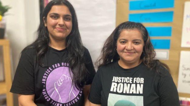 Nikita and her mother Pooja Kanda, two South Asian women wearing t-shirts calling for justice for Ronan Kanda