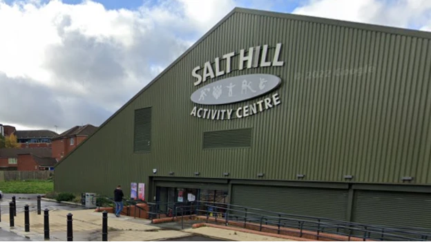 A general view picture of the Salt Hill Activity Centre, which is a large, green building made from corrugated metal.