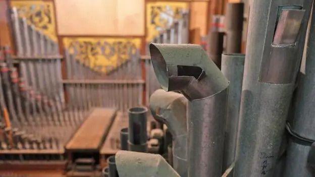 The organ's pipes at Wells Cathedral from close up.