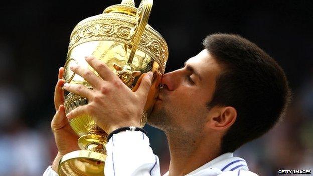 Djokovic kisses the Wimbledon trophy