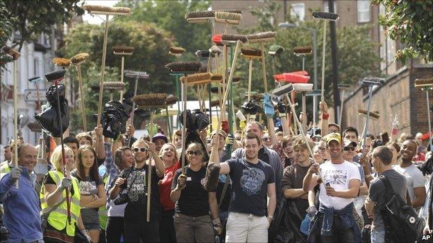 Crowd holding brushes in Clapham Junction