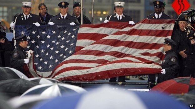 The World Trade Center flag is folded during a memorial service in New York for the victims of the attacks.