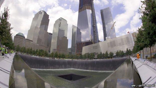 A view of the south pool waterfall with the Freedom Tower in the background at the World Trade Center site in New York