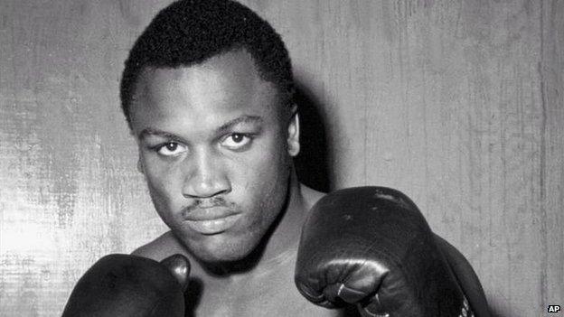 Joe Frazier posing in boxing gloves