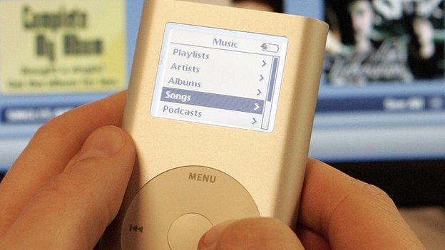 Close up of ipod with computer in background
