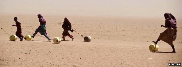 Refugees with water containers