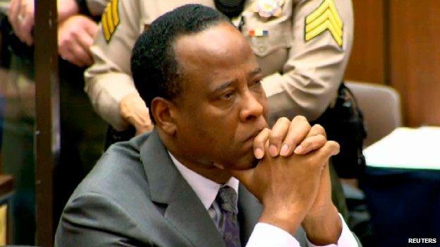 Michael Jackson's former doctor, Conrad Murray, listens as a judge sentences him to four years in prison