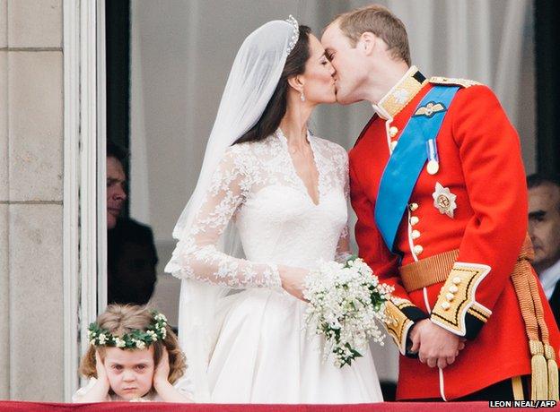 Prince William and his newly titled bride the Duchess of Cambridge kiss on the balcony of Buckingham Palace