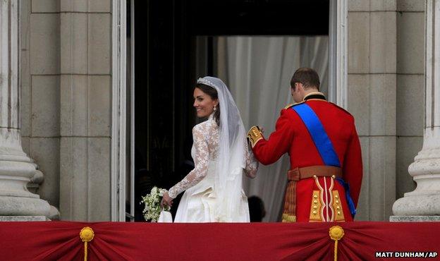 Kate, Duchess of Cambridge, and Prince William go back inside having greeted the crowds on the balcony of Buckingham Palace