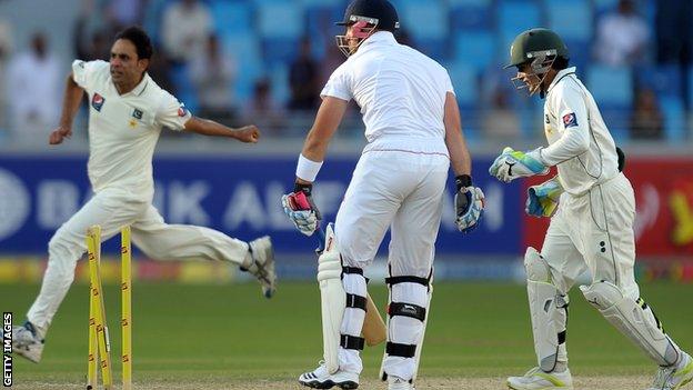 Matt Prior (centre) is bowled by Abdur Rehman (left)