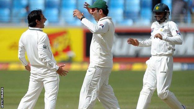 Pakistan's Saeed Ajmal, captain Misbah-ul-Haq and Azhar Ali celebrate a wicket