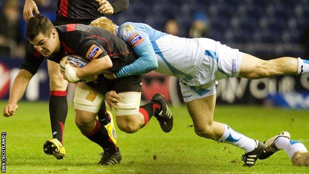 Edinburgh's Stuart McInally is tackled by Ospreys' Hanno Dirksen (right)