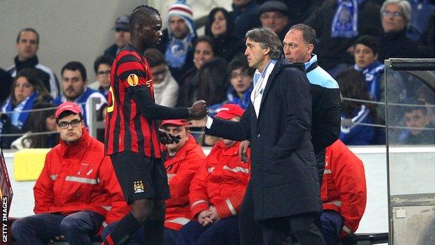 Mario Balotelli is consoled by manager Roberto Mancini