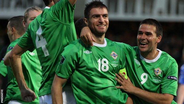 Aaron Hughes with Northern Ireland's record goalscorer David Healy