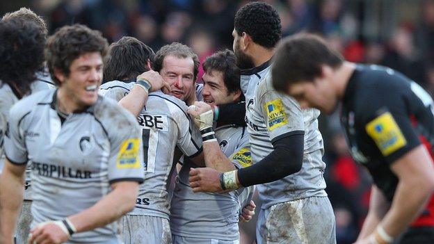 Geordan Murphy is mobbed by Leicester players for his drop-goal against Saracens