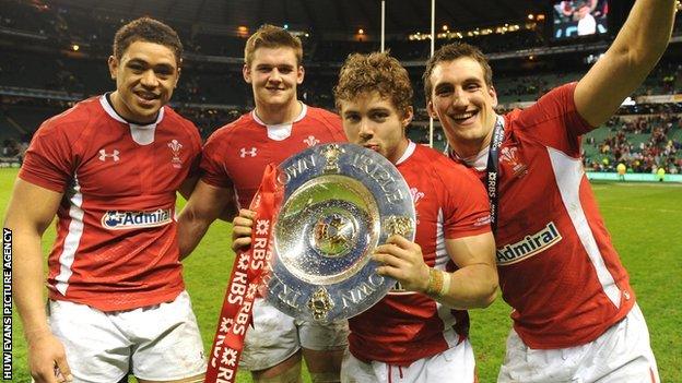 Leigh Halfpenny holds the Triple Crown trophy alongside Wales team-mates (L-R) Toby Faletau, Dan Lydiate and Sam Warburton