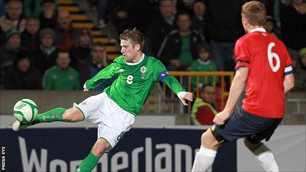 Northern Ireland skipper Steven Davis shoots during the match against Norway