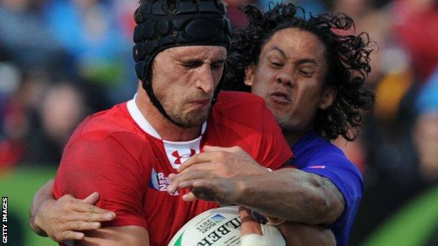 Wales lock Luke Charteris is tackled by Samoa fly-half Tusi Pisi