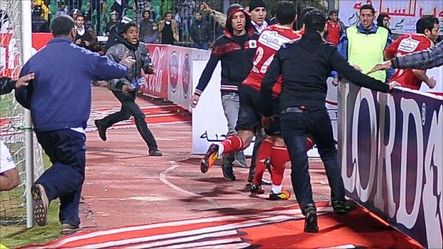 Al Masry fans run after Al Ahly players