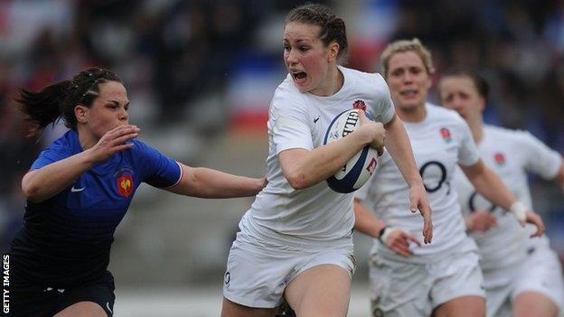 Emily Scarratt of England tries to break away as Elodie Poublan of France goes in for the tackle during the Womens RBS Six Nations match between France and England at Stade Charlety