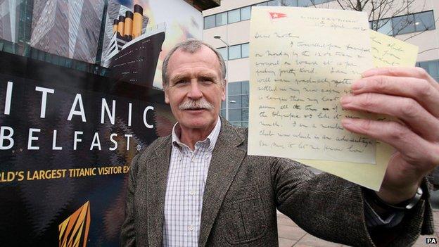 Dr John Martin holding a copy of the letter written by his great uncle whilst aboard the Titanic