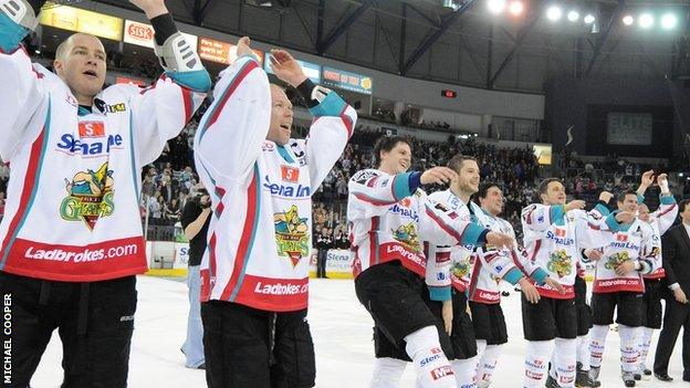 Giants players celebrate with fans after winning the Elite League title