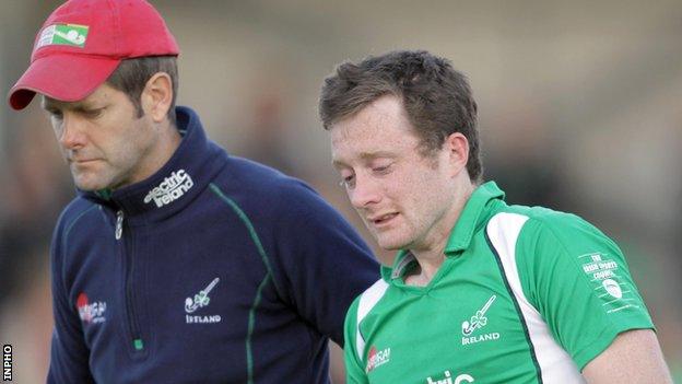 Ireland coach Paul Revington consoles player John Jackson after the final whistle