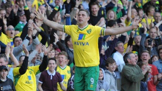 Grant Holt celebrates scoring his first goal