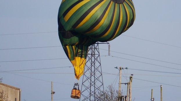 A hot air balloon stuck gets stuck in power lines in Northamptonshire.