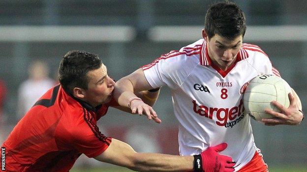 Down's David McKibben challenges Tyrone's Richard Donnelly at Casement Park