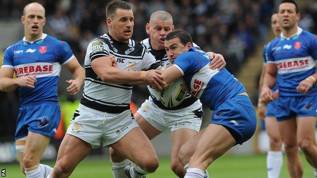 Hull Kingston Rovers' Shannon McDonnell is tackled by Hull FC's Brett Seymour and Lee Radford