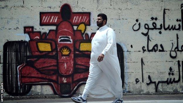 A man walks past anti-Bahrain GP graffiti