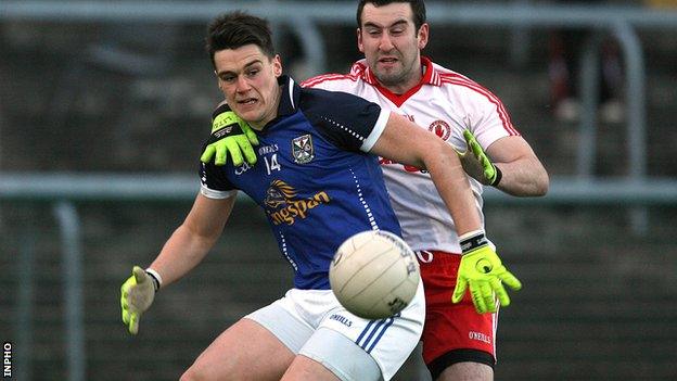 Cavan's Kevin Tierney is challenged by Tyrone's Dean McNally