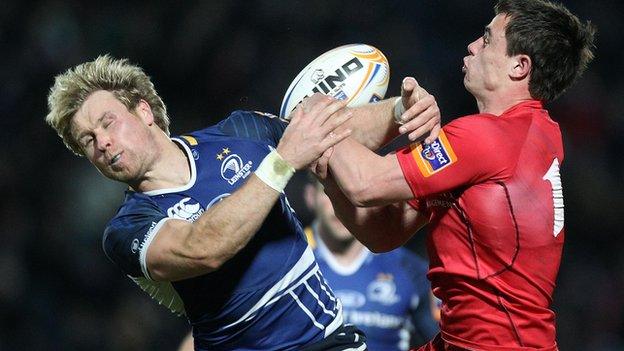 Fionn Carr jumps with Glasgow's Lee Jones