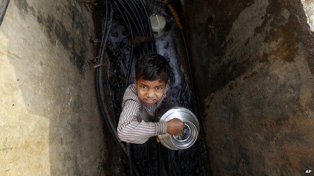 A boy trying to find clean water