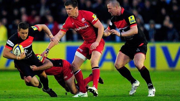 Falcons player Jimmy Gopperth is tackled by Charlie Hodgson and Owen Farrell during the Aviva Premiership match between Newcastle Falcons and Saracens