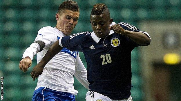 Scotland debutant Islam Feruz makes his way past Federico Viviani (left)