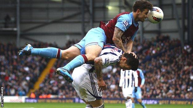 Aston Villa's Chris Herd challenges West Brom's Liam Ridgewell