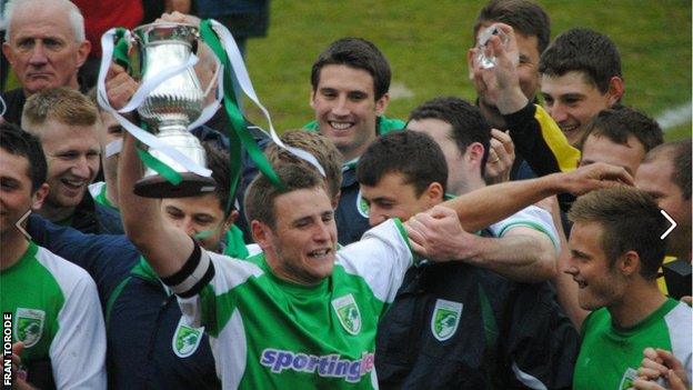 Guernsey skipper Sam Cochrane lifts the Combined Counties League Division One trophy