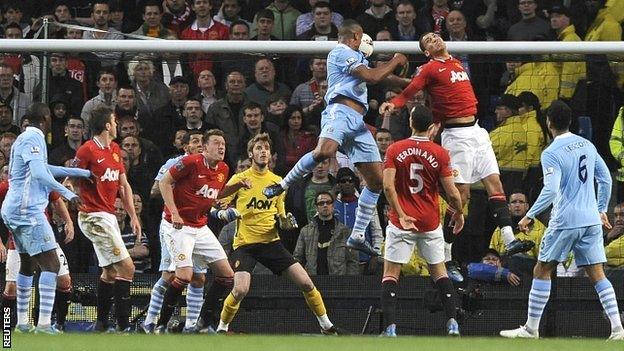 Vincent Kompany rises to head in