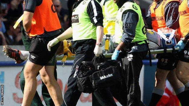 Tom Croft being stretchered off against Harlequins