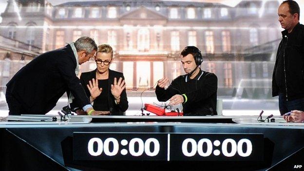 French journalist Laurence Ferrari (2nd L) talks to a colleague before Wednesday's debate