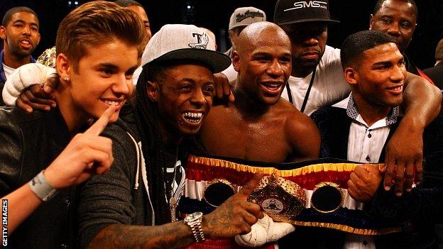 Singer Justin Bieber, Rapper Lil Wayne, boxer Floyd Mayweather, rapper Curtis "50 Cent" Jackson and guest pose after Mayweather's win over Miguel Cotto