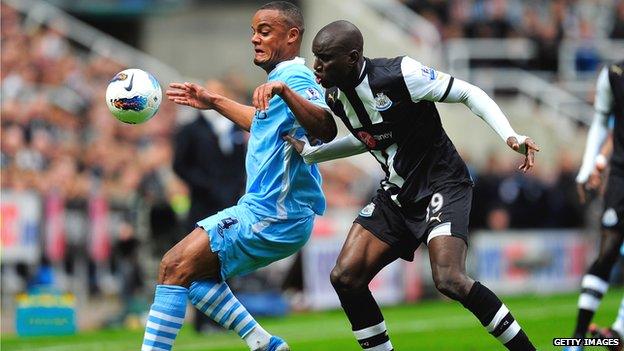 Vincent Kompany and Demba Ba fight for the ball