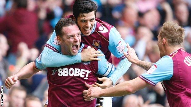 Kevin Nolan (left) celebrates scoring the opening goal with team-mate James Tomkins and Jack Collison (right)